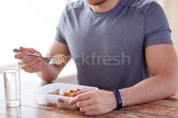 close up of man with fork and water eating food Stock photo © dolgachov