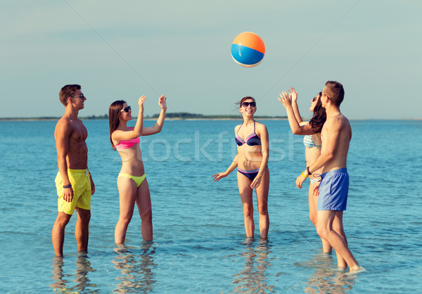 smiling friends in sunglasses on summer beach Stock photo © dolgachov