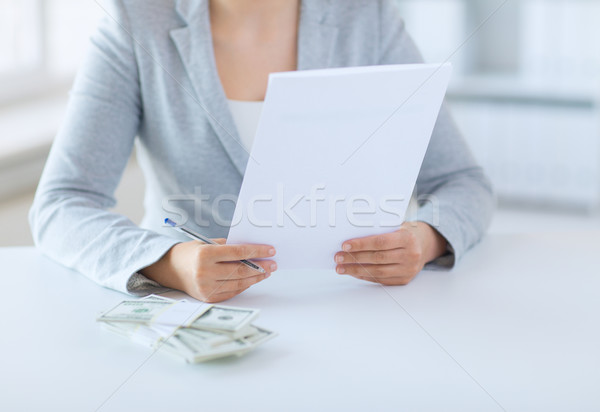 close up of female hands with money and tax report Stock photo © dolgachov