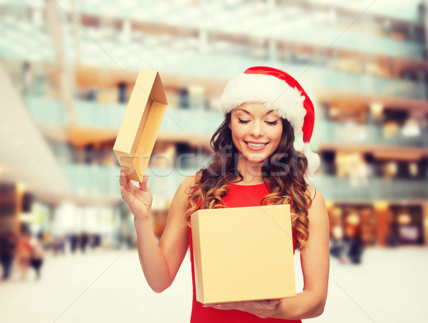 smiling woman in santa helper hat with gift box Stock photo © dolgachov