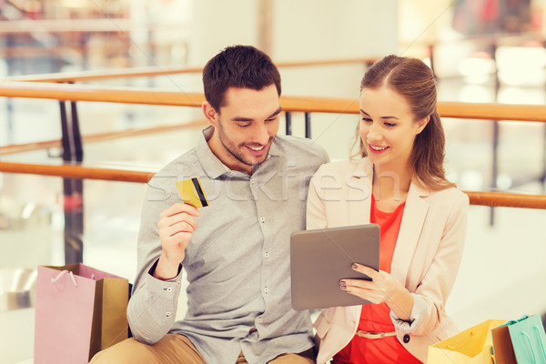 couple with tablet pc and credit card in mall Stock photo © dolgachov