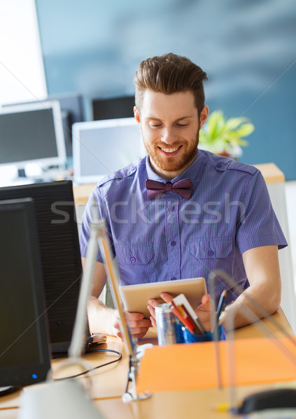 happy creative male office worker with tablet pc Stock photo © dolgachov