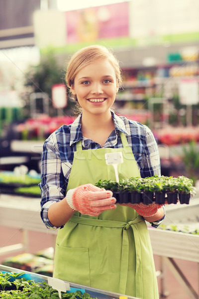 happy woman holding seedling in greenhouse Stock photo © dolgachov