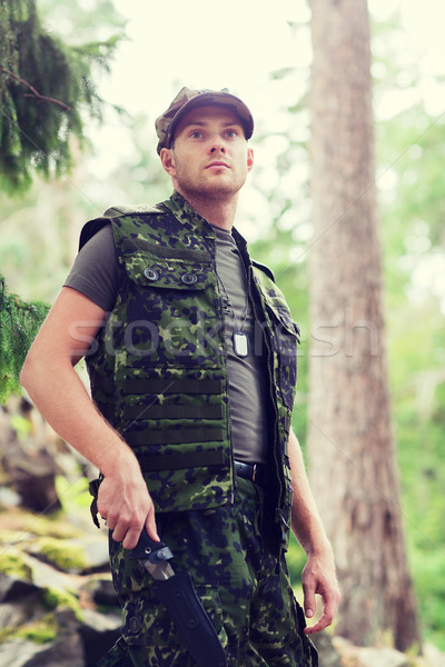 Stock photo: young soldier or hunter with knife in forest