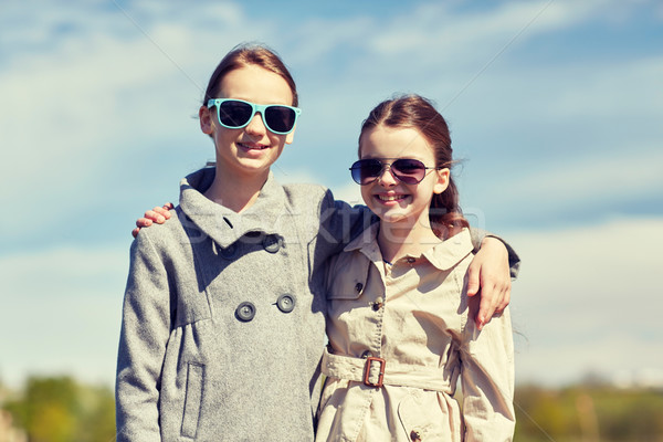 happy little girls in sunglasses hugging outdoors Stock photo © dolgachov