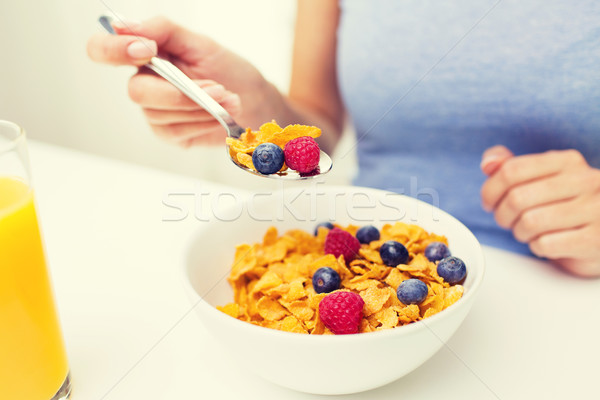 close up of woman eating corn flakes for breakfast Stock photo © dolgachov