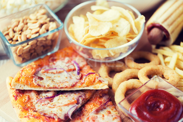 close up of fast food snacks on wooden table Stock photo © dolgachov