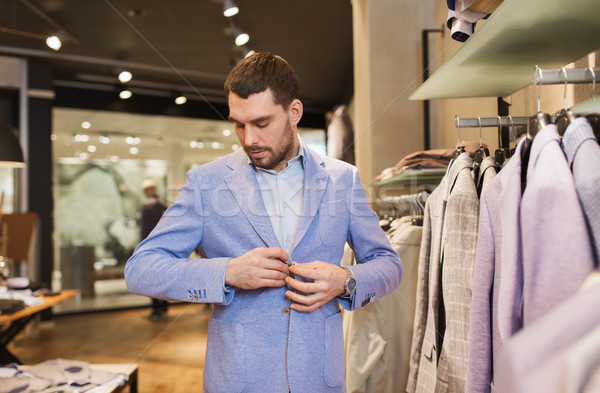 Heureux jeune homme veste vêtements magasin vente [[stock_photo]] © dolgachov