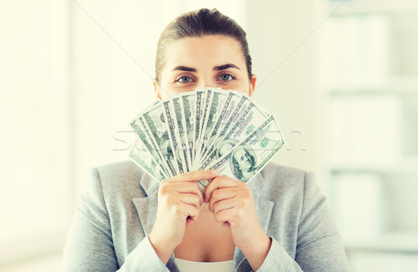 woman hiding her face behind us dollar money fan Stock photo © dolgachov