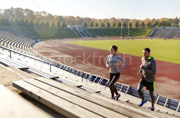 Szczęśliwy para uruchomiony na górze stadion fitness Zdjęcia stock © dolgachov