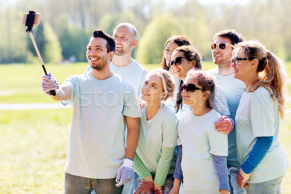 group of volunteers taking smartphone selfie Stock photo © dolgachov