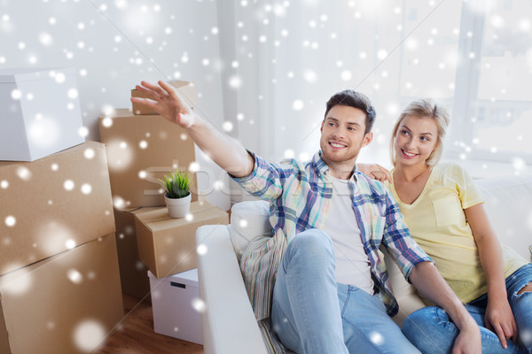 couple with boxes moving to new home and dreaming Stock photo © dolgachov