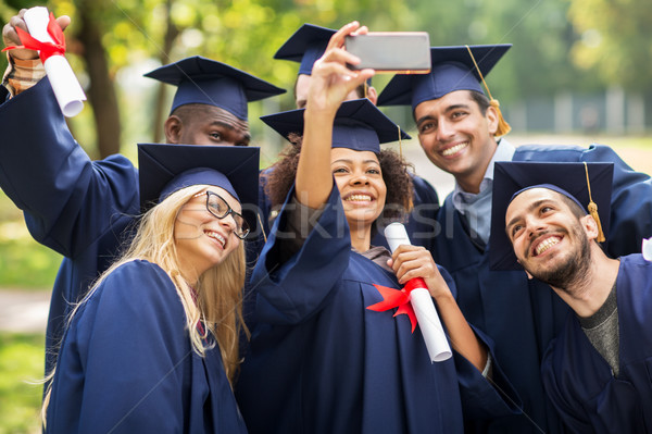 Studentów kawalerowie smartphone edukacji ukończeniu Zdjęcia stock © dolgachov