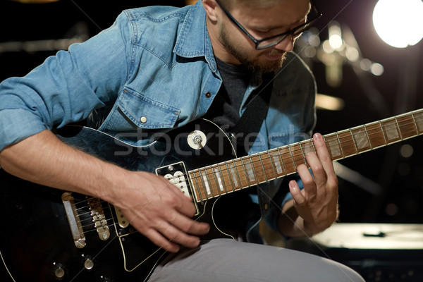close up of man playing guitar at studio rehearsal Stock photo © dolgachov