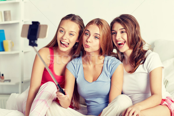 teen girls with smartphone taking selfie at home Stock photo © dolgachov