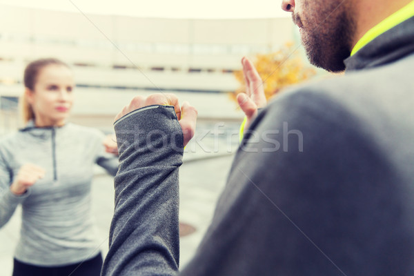 close up of woman with trainer working strike out Stock photo © dolgachov