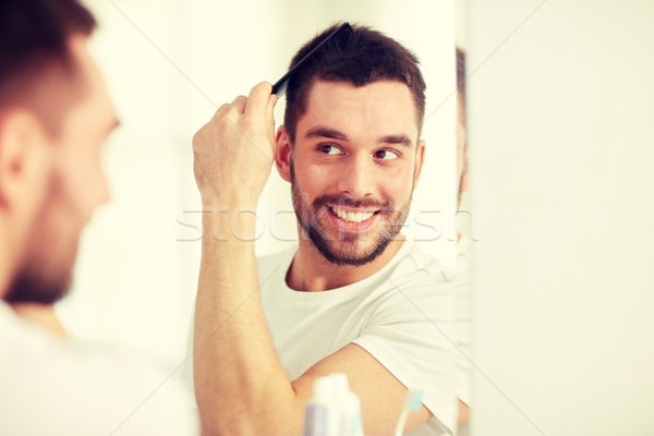 Szczęśliwy człowiek włosy grzebień łazienka piękna Zdjęcia stock © dolgachov