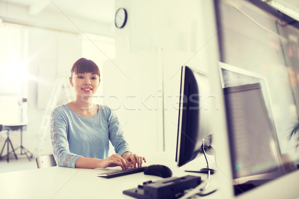 happy asian woman with computer at office Stock photo © dolgachov