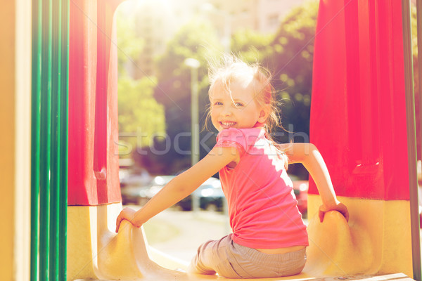 happy little girl on slide at children playground Stock photo © dolgachov