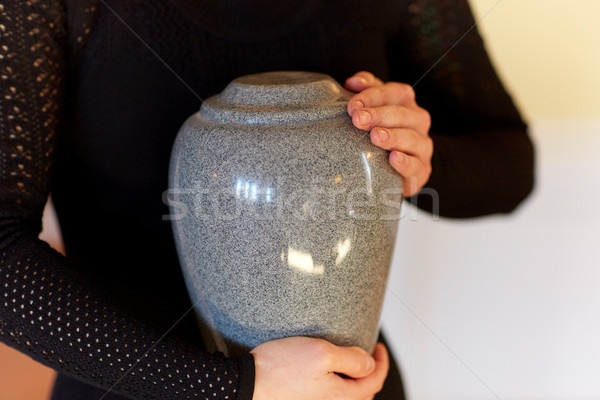 close up of woman with cremation urn at funeral Stock photo © dolgachov