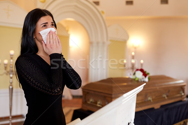 woman with coffin crying at funeral in church Stock photo © dolgachov