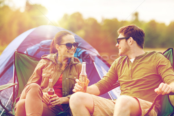 happy couple drinking beer at campsite tent Stock photo © dolgachov