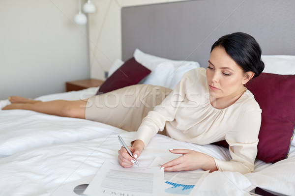 businesswoman with papers working at hotel room Stock photo © dolgachov