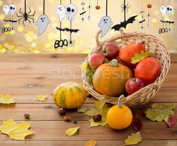 pumpkins in basket and halloween party garland Stock photo © dolgachov