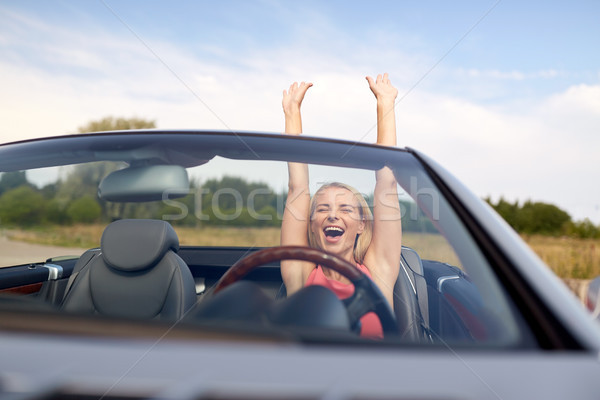 happy young woman in convertible car Stock photo © dolgachov