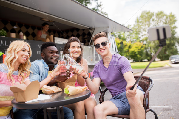happy young friends taking selfie at food truck Stock photo © dolgachov