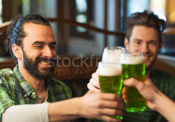 Stock photo: male friends drinking green beer at bar or pub