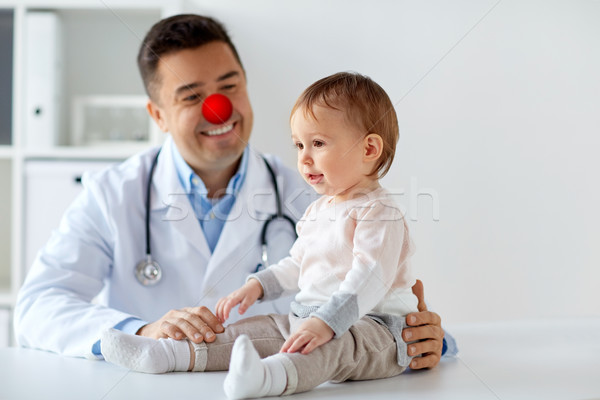 happy baby girl at doctor on red nose day Stock photo © dolgachov