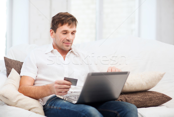 man with laptop and credit card at home Stock photo © dolgachov
