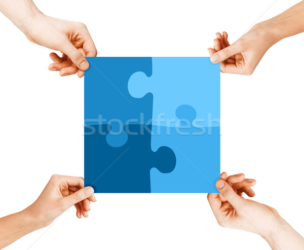 Négy kezek kapcsolódik kirakó darabok üzlet csapatmunka Stock fotó © dolgachov