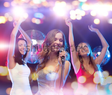 Tres sonriendo mujeres baile club año nuevo Foto stock © dolgachov