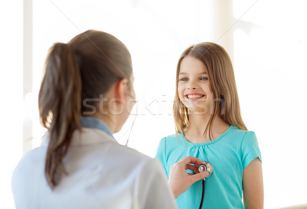 female doctor with stethoscope listening to child Stock photo © dolgachov