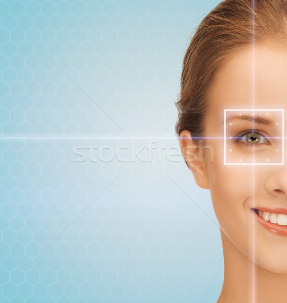 smiling young woman with laser light lines Stock photo © dolgachov