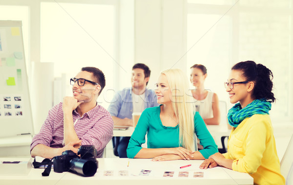 smiling team with photocamera working in office Stock photo © dolgachov