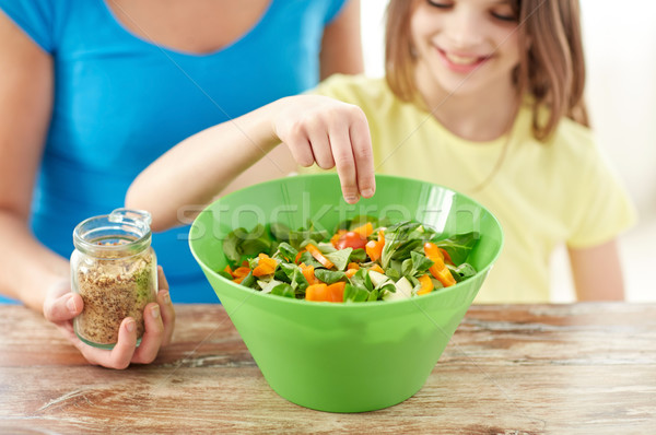 close up of happy family cooking salad in kitchen Stock photo © dolgachov