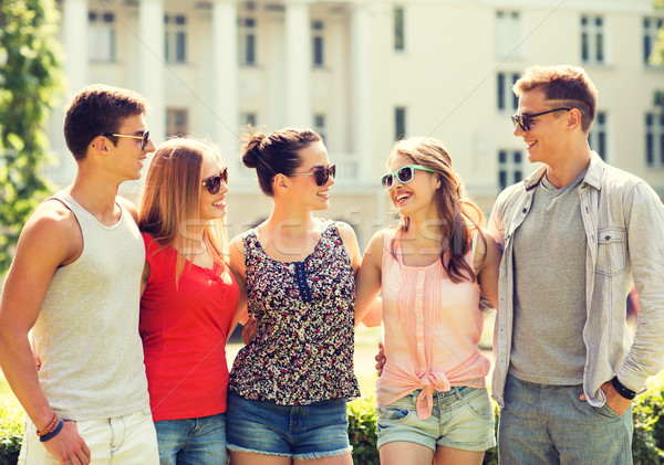 group of smiling friends outdoors Stock photo © dolgachov