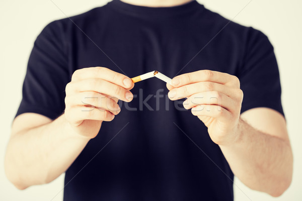 man breaking the cigarette with hands Stock photo © dolgachov