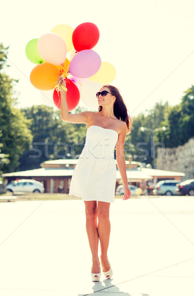 Stock photo: smiling young woman in sunglasses with balloons