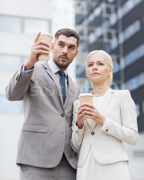 Stock photo: serious businessmen with paper cups outdoors