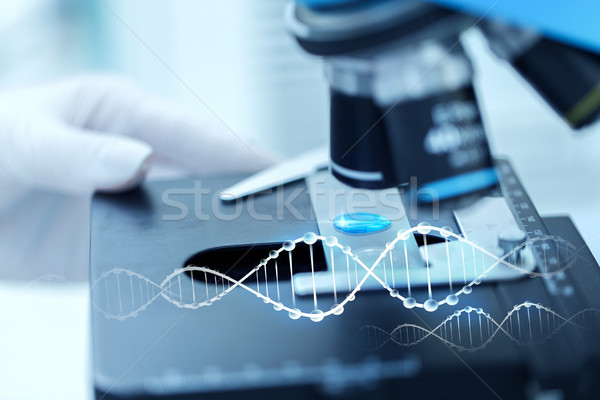 close up of scientist hand with test sample in lab Stock photo © dolgachov