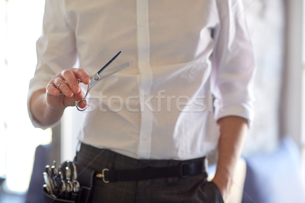 close up of male stylist with scissors at salon Stock photo © dolgachov