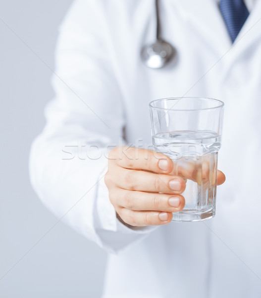 doctor hands giving glass of water Stock photo © dolgachov