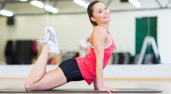 beautiful sporty woman doing exercise at gym Stock photo © dolgachov