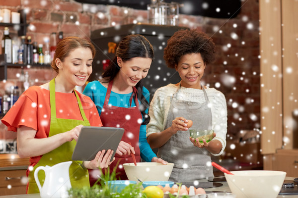 happy women with tablet pc cooking in kitchen Stock photo © dolgachov