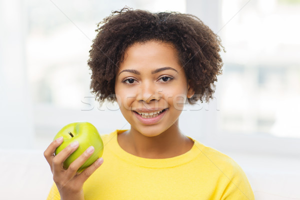 happy african american woman with green apple Stock photo © dolgachov