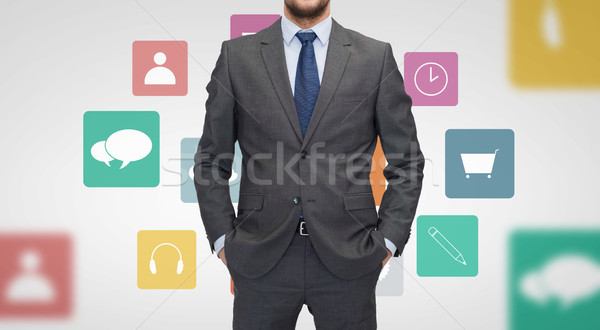 close up of businessman in suit with menu icons Stock photo © dolgachov